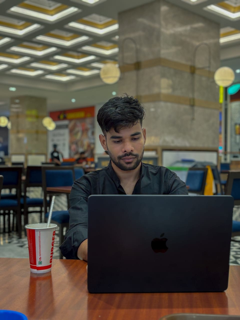 Professional Photo of Afsar Azam working on laptop
